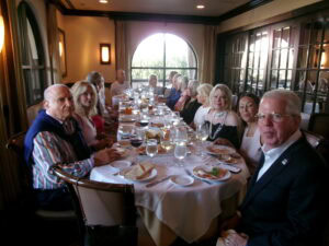 Tom Van Horn and members of the Happiness Club Social Club seated around a table for a lunch learning workshop at Cafe Sapori